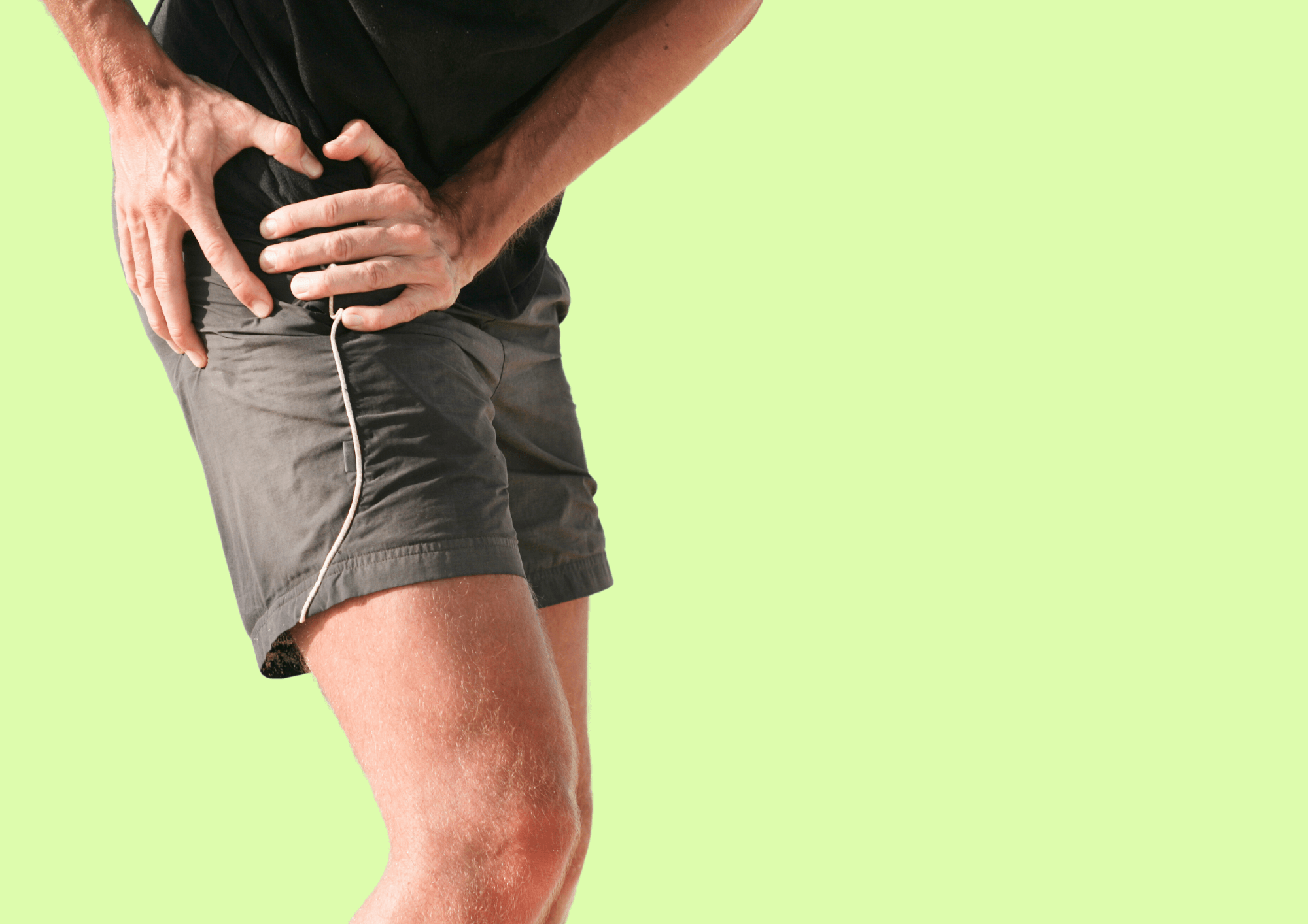 Man holds on to his hip because he has hip pain.